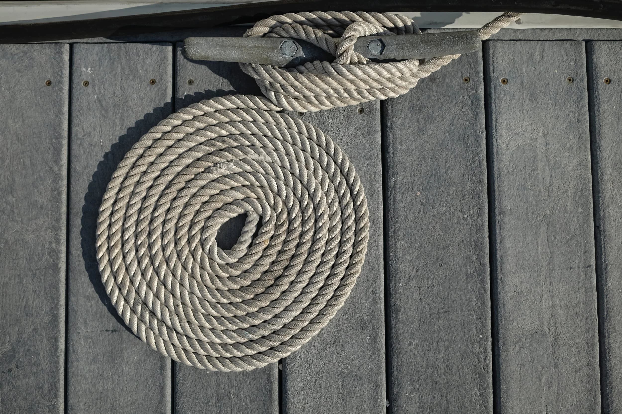 Coiled dock line on a cleat at Wareham Marina